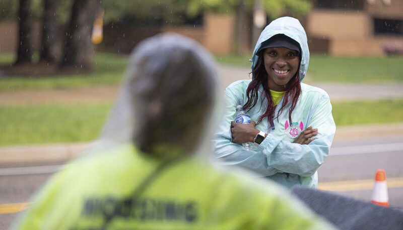 Two students standing outside in the rain