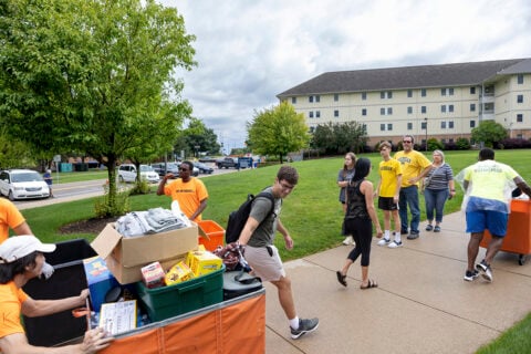 Students pulling items into First Street Residence Hal.