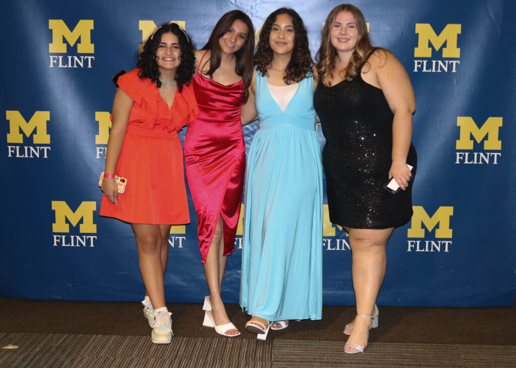 Four UM-Flint students pose for a photo at the Wolverine Homecoming Dance in 2022.