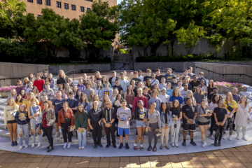 A large group of students posing in McKinnon Plaza