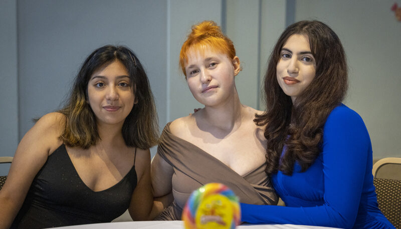 students posing for the camera at a table