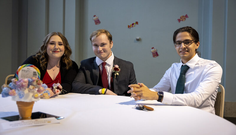 Students smiling for the camera at a table