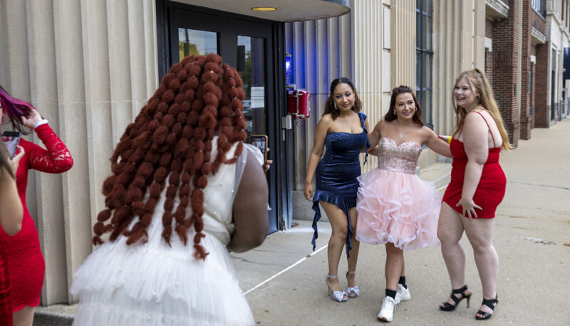 students in formal dresses posing outside of the Northbank Center