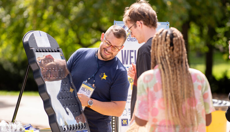 Students looking at a panel of technology