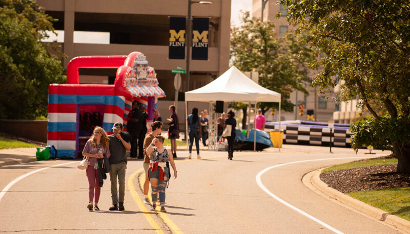 A group of students walking down Kearsley Street during the carnival