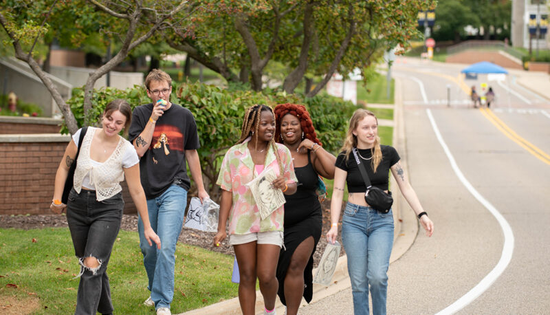 A group of students walking down Kearsley St. during the carnival