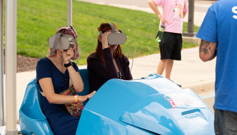 Two students in a VR car game