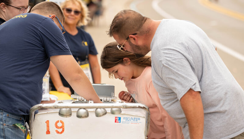 A father and daughter looking into an ice cream trolley