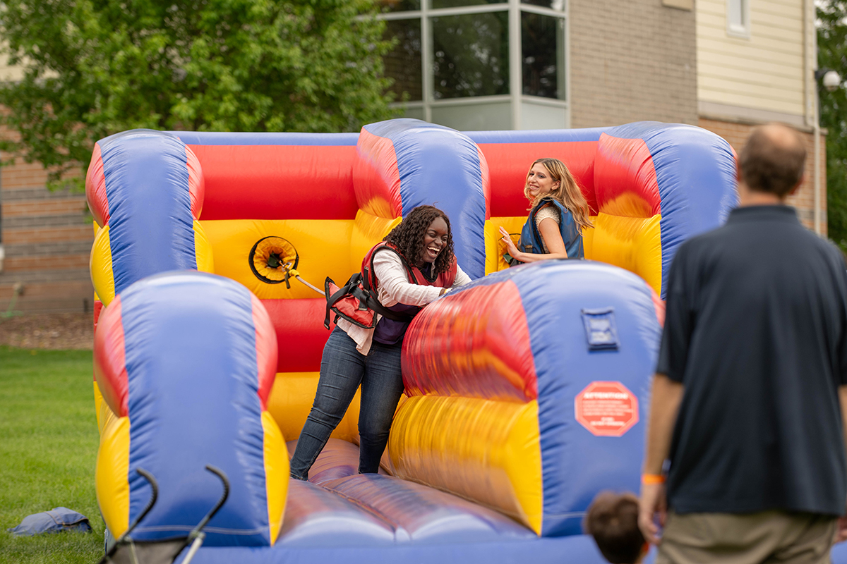 Students playing on an inflatable carnival game