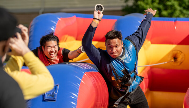 students playing an inflatable carnival game