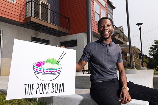 Jeron Dotson sitting outside of the Poke Bowl