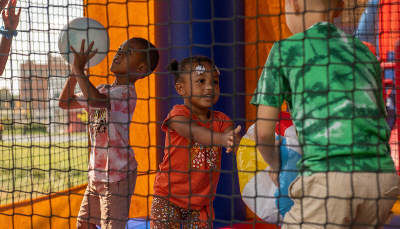 kids playing in inflatable houses