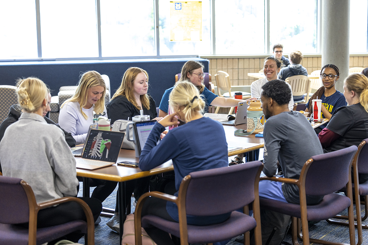 A group of students sitting a table studying