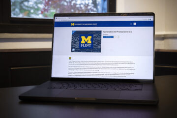 A laptop with the UM-Flint Generative AI Prompt Literacy course on the screen