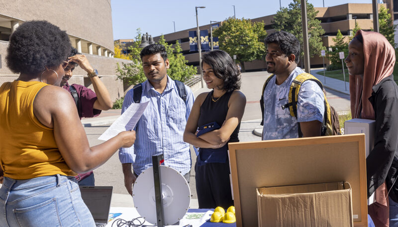 A group of students talking at a table at Eco Extravaganza