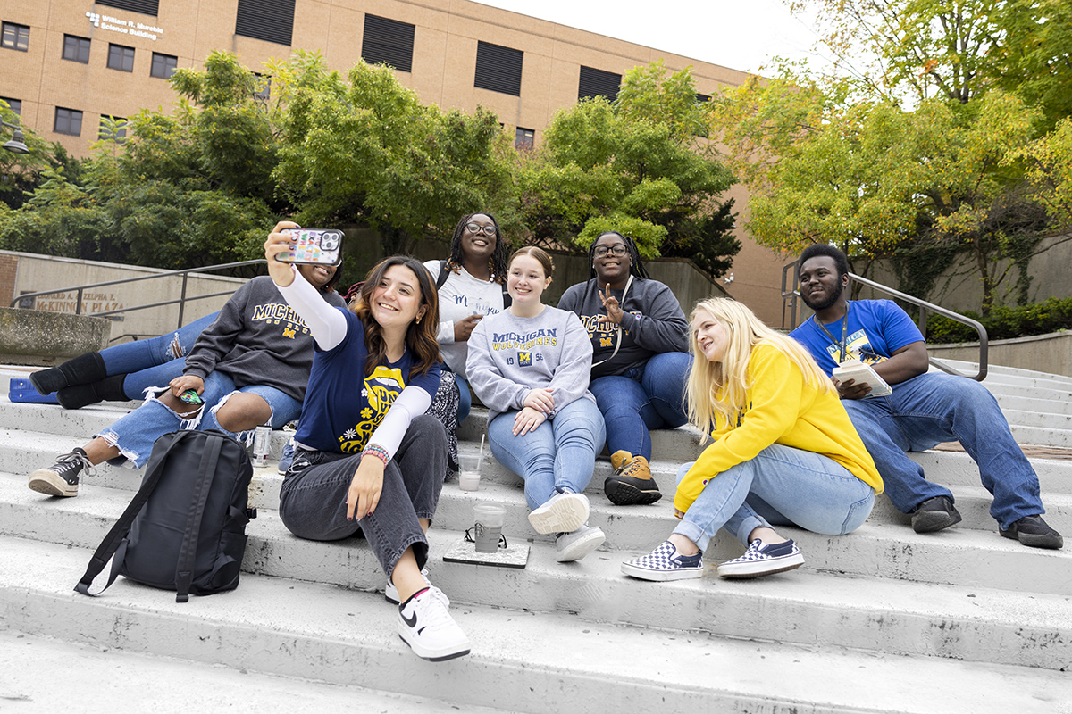 A group of students taking a selfie in McKinnon Plaza