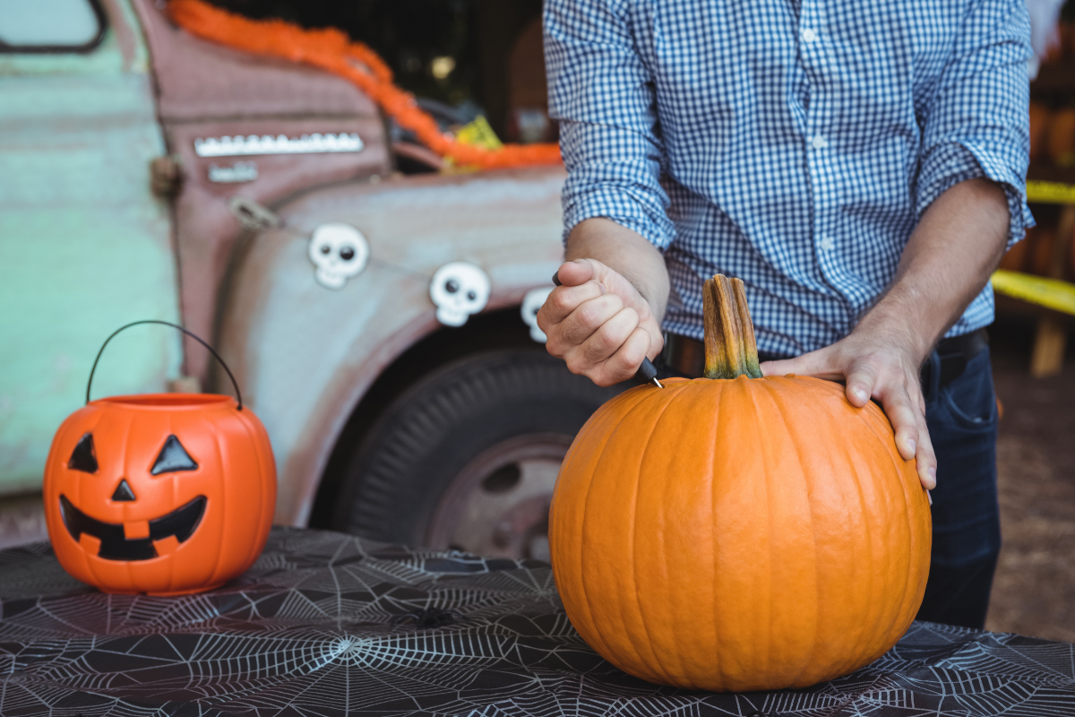 A man carving a pumpkin