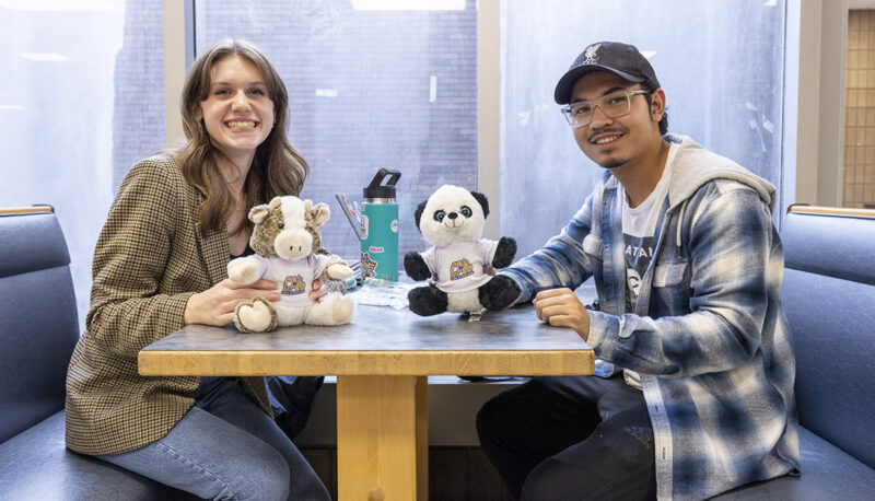 Two students showing off their plushies