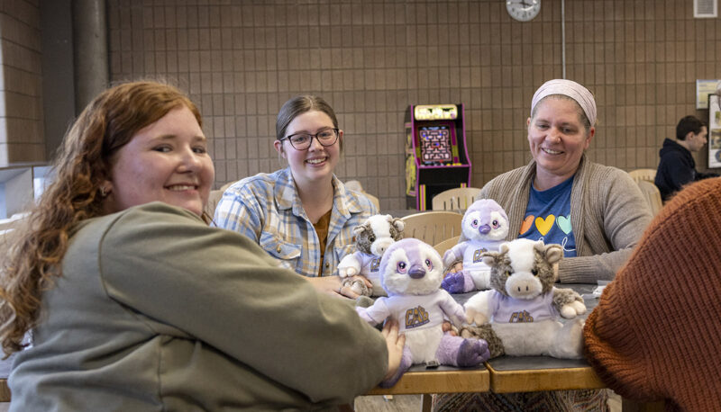 A group of students smiling with their plushies