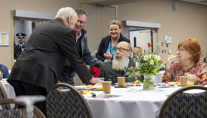 Two men shaking hands during the Veterans Day reception