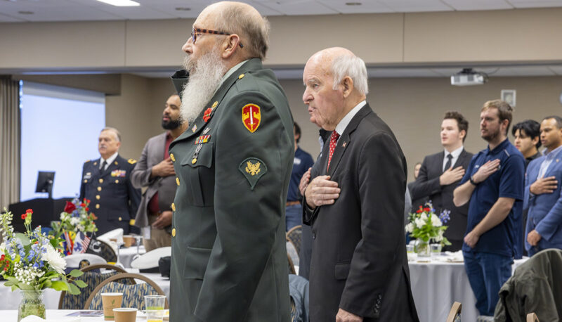 People standing for the National Anthem at the Veterans Day reception