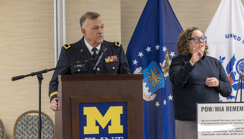 Michigan National Guard Brig. Gen Michael McDaniel (retired) speaking at a podium.