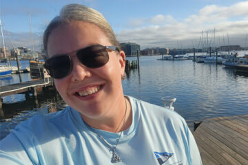 Occupational therapy alum Shanna Haver poses in front of the water at the Downtown Sailing Center in Baltimore, Maryland.