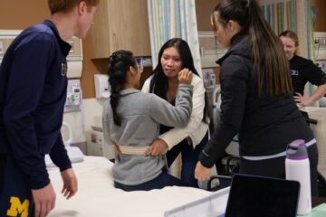 UM-Flint students work on patient transferring techniques during a recent workshop.