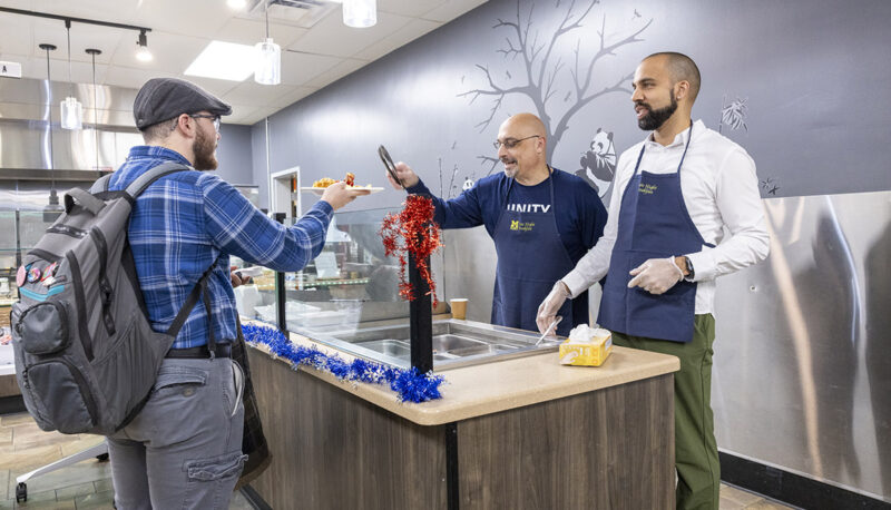 UM-Flint staffers serving students food