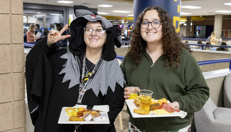 Students holding food posing for the camera