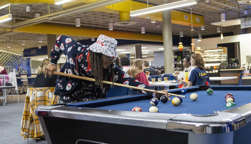 A student shooting pool