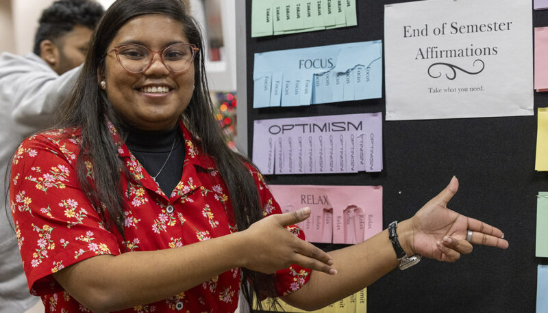 A student pointing to an affirmation board