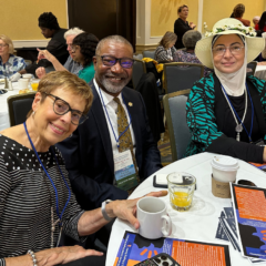 Three representatives from UM-Flint's School of Nursing sit around a conference table