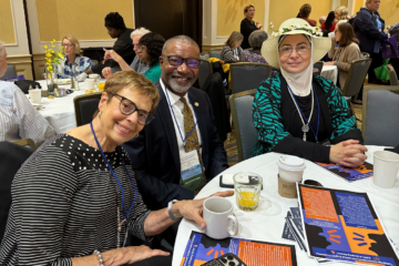 Three representatives from UM-Flint's School of Nursing sit around a conference table