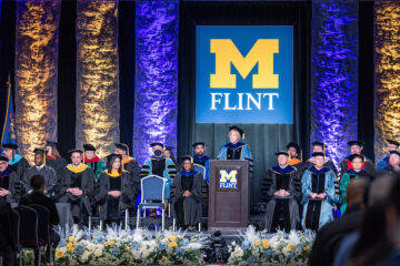 Interim Chancellor Donna Fry speaking at the podium during Commencement.