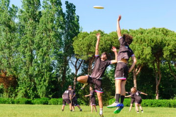 An action shot of people playing Ultimate Frisbee