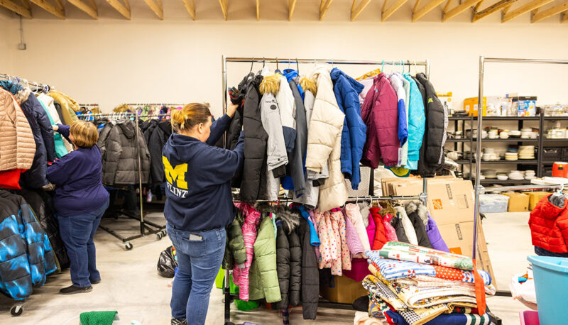 A UM-Flint staffer sorting winter clothes