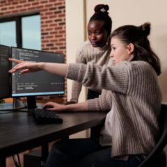 Two people looking at a computer screen