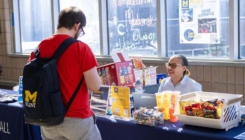 A student talking at a Giving Blueday table