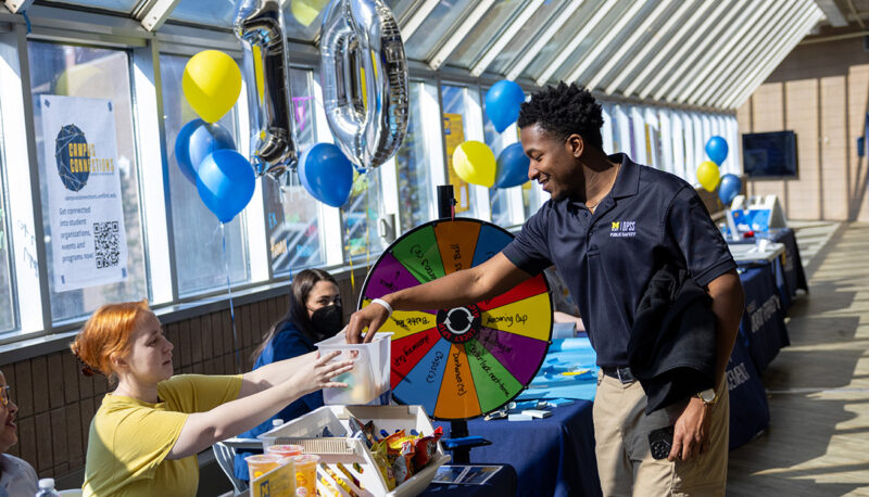 A student winning a prize at a Giving Blueday table