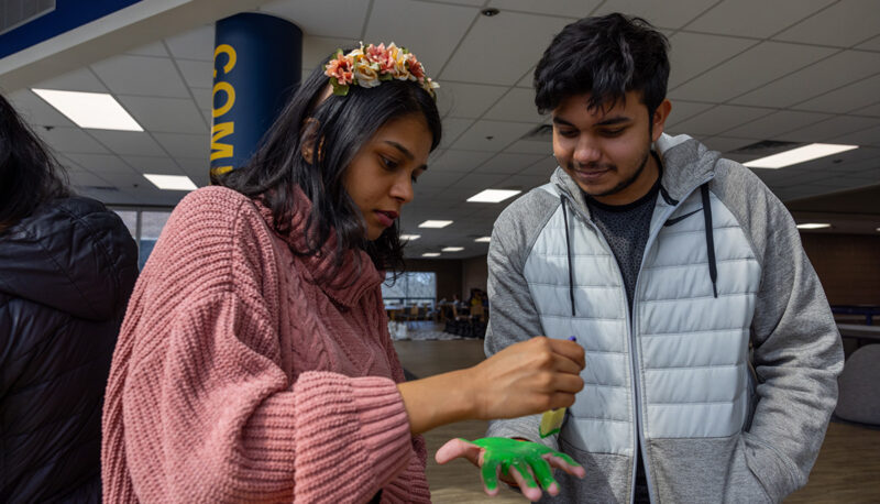 One student painting another's palm