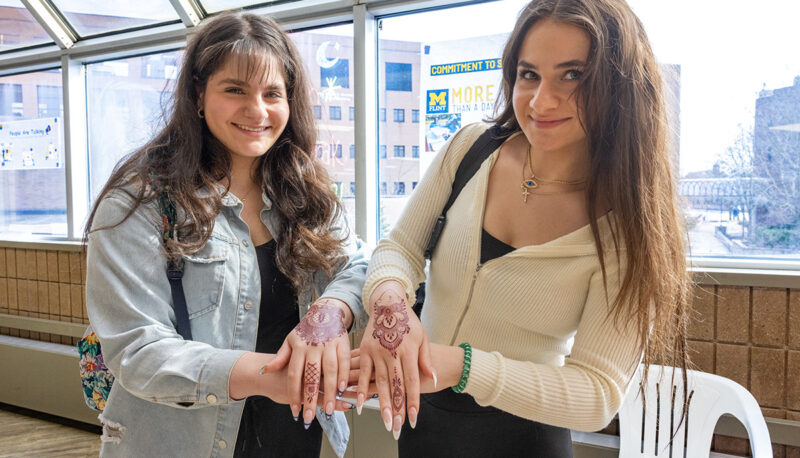 Two students showing off their henna tattoos