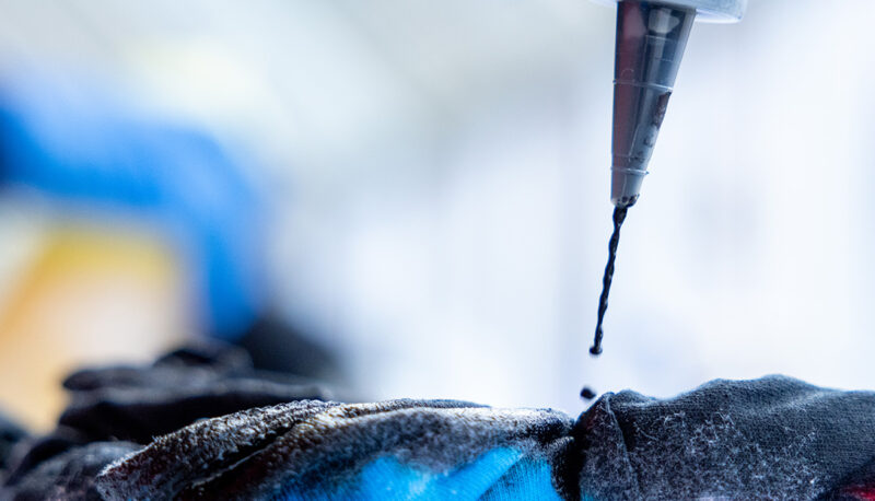 A close up of dye being applied to a t shirt