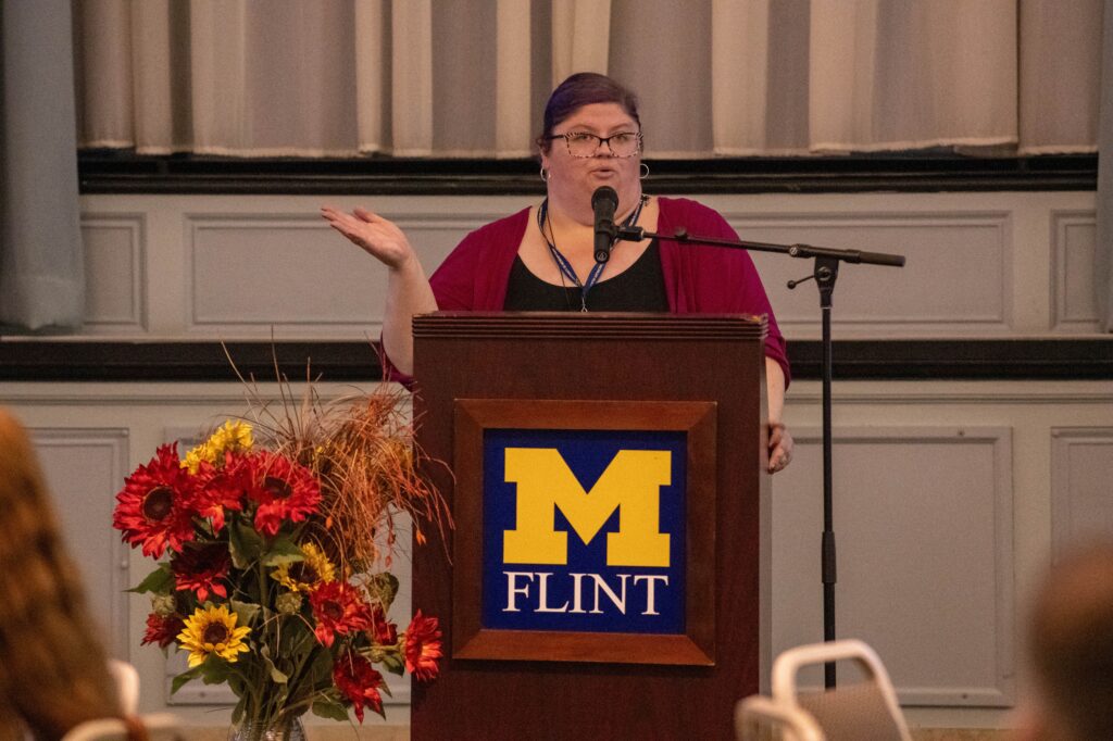 Kimberly Saks speaking at a podium. 