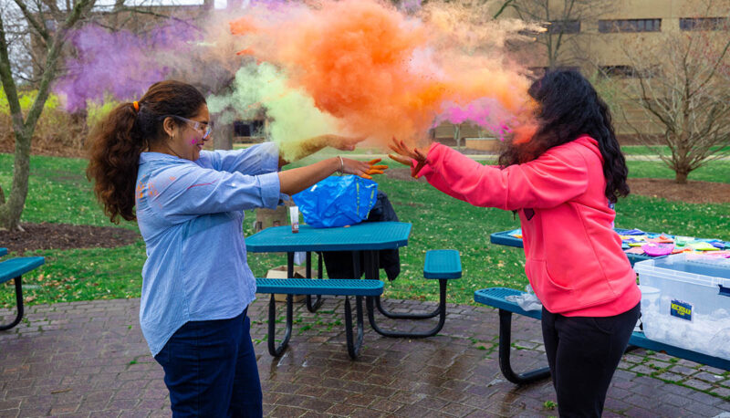 UM-Flint Holi celebration. During this celebration, students cover each other in colored paints as part of a traditional spring celebration.