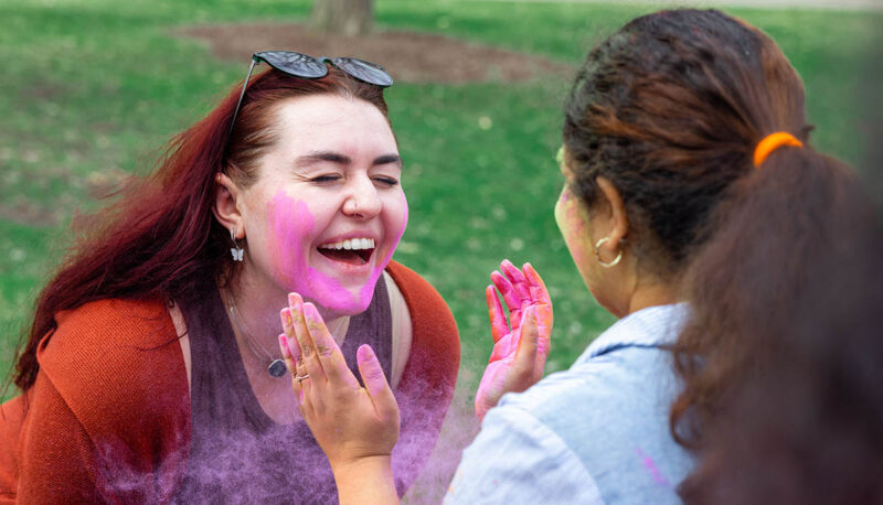 UM-Flint Holi celebration. During this celebration, students cover each other in colored paints as part of a traditional spring celebration.