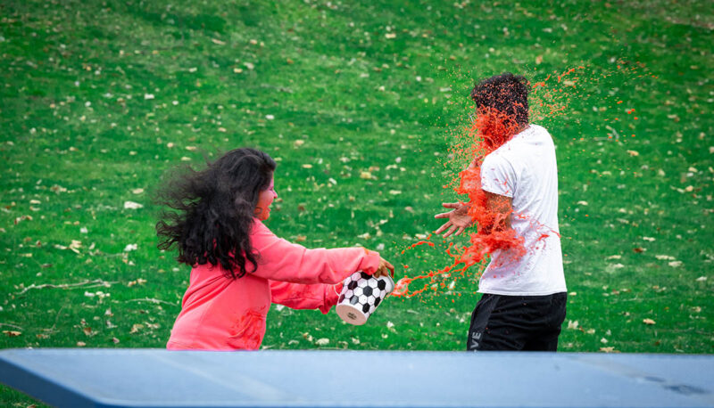 UM-Flint Holi celebration. During this celebration, students cover each other in colored paints as part of a traditional spring celebration.