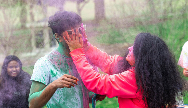 UM-Flint Holi celebration. During this celebration, students cover each other in colored paints as part of a traditional spring celebration.