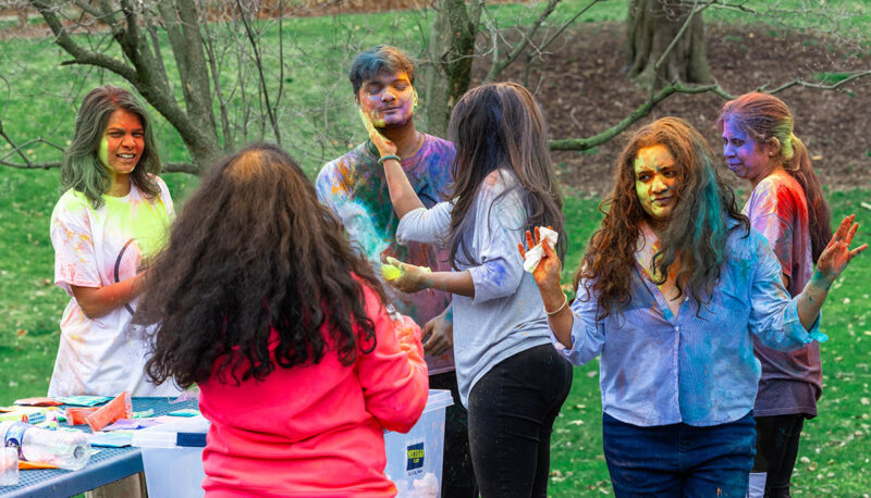 UM-Flint Holi celebration. During this celebration, students cover each other in colored paints as part of a traditional spring celebration.