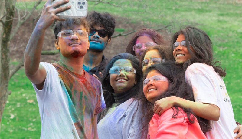 UM-Flint Holi celebration. During this celebration, students cover each other in colored paints as part of a traditional spring celebration.